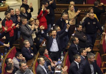 Ukrainian opposition members celebrate during the voting in parliament in Kiev