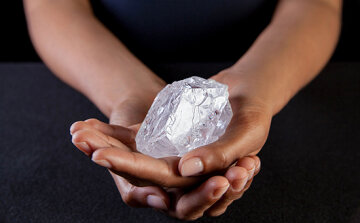 A Sotherby's  employee  holds Lesedi La Rona Diamond on May Tuesday  3, 2016 in New York City. The diamond the size of a tennis ball that is the largest discovered in more than a century could sell at auction for more than $70 million. Sotheby's says it will offer the Lesedi la Rona diamond in London on June 29.  (Donald Bowers/Getty Images for Sotheby's, via AP)