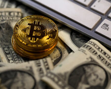Bitcoin (virtual currency) coins placed on Dollar banknotes are seen in this illustration picture