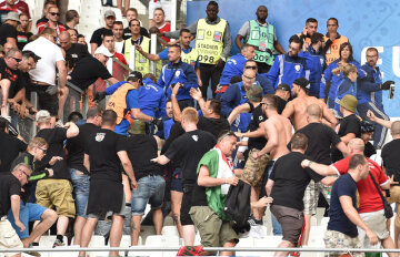 epa05375250 Hungarian supporters clash with police (blue) in the stands before the UEFA EURO 2016 group F preliminary round match between Iceland and Hungary at Stade Velodrome in Marseille, France, 18 June 2016. (RESTRICTIONS APPLY: For editorial news reporting purposes only. Not used for commercial or marketing purposes without prior written approval of UEFA. Images must appear as still images and must not emulate match action video footage. Photographs published in online publications (whether via the Internet or otherwise) shall have an interval of at least 20 seconds between the posting.)  EPA/PETER POWELL   EDITORIAL USE ONLY