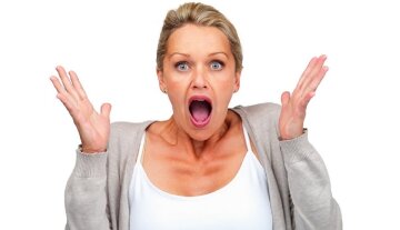 Surprised woman isolated against white background