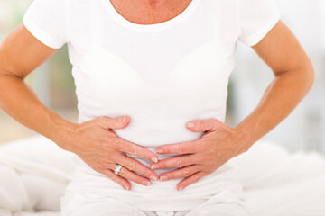 mid age woman having stomach pain