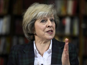 Britain’s Home Secretary Theresa May attends a press conference in London