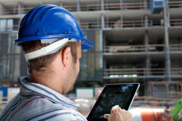 Construction specialist using a tablet computer