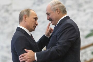 Belarus’ President Lukashenko greets his Russian counterpart Putin at a meeting during a CIS s