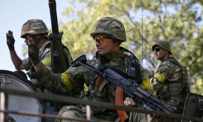 Ukrainian servicemen ride in an armoured vehicle near Kramatorsk