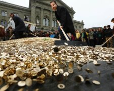 Committee members spread five cent coins over Federal Square during an event organised by the Commit