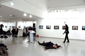 Russian Ambassador to Turkey Karlov lies on the ground after he was shot by unidentified man at an a