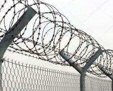 depositphotos_12713198-stock-photo-fence-with-a-barbed-wire