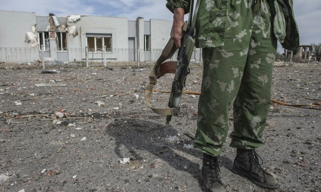 A pro-Russian rebel holds his rifle at the destroyed airport in Luhanks, eastern Ukraine
