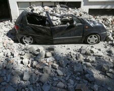 A destroyed car is seen following an earthquake in Amatrice