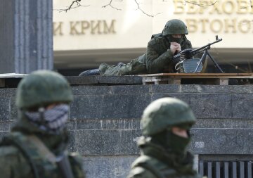 Armed men take up positions around the regional parliament building in the Crimean city of Simferopo