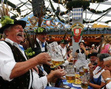 Revellers salute with beer after the opening of the 179th Oktoberfest in Munich