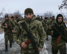 Pro-Russian separatists from the Chechen «Death» battalion walk during a training exercise