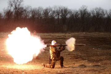 A volunteer of the separatist self-proclaimed Donetsk People’s Republican guard fires a rocket