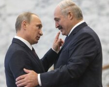 Belarus’ President Lukashenko greets his Russian counterpart Putin at a meeting during a CIS s