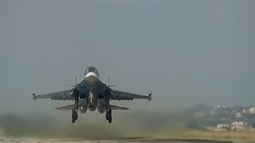 A still image shows a Russian jet taking off in Syria