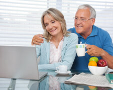 Happy Couple Using Laptop