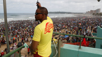 A lifeguard looks on as revellers enjoy New Year's Day on a beach in Durban, South Africa January 1, 2017. REUTERS/Rogan Ward