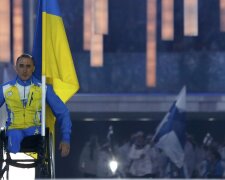 Ukraine’s flag-bearer Tkachenko arrives in the stadium during the opening ceremony of the 2014