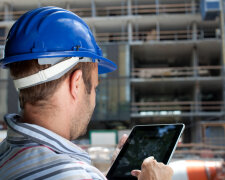 Construction specialist using a tablet computer