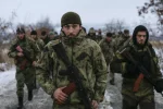 Pro-Russian separatists from the Chechen «Death» battalion walk during a training exercise