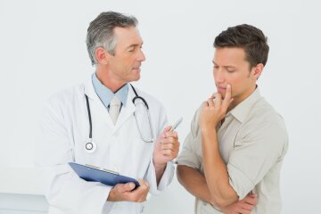 Male doctor in conversation with patient in the medical office