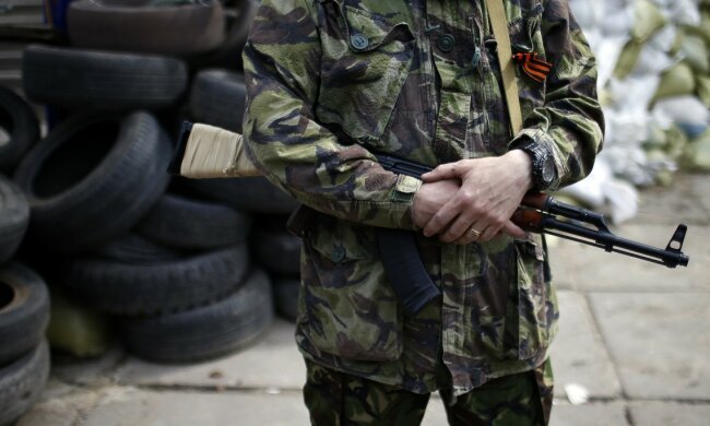 An armed pro-Russian rebel stands guard outside the town hall in Mariupol