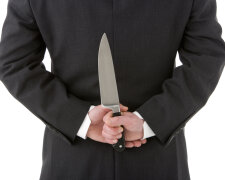 Businessman Holding Knife Behind His Back