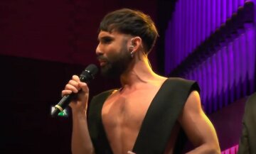 Звезда "Евровидения" Кончита Вурст в коротком платье прильнула к мускулистому мачо в латексе: кадры безобразия