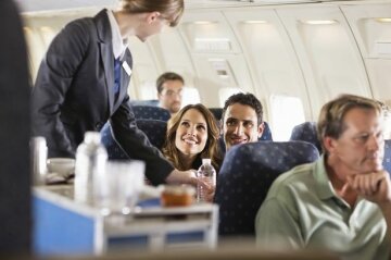 Flight-attendant-serving-customers-on-an-airplane