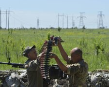 Members of the Ukrainian armed forces prepare a weapon at their position located near the town of Ho