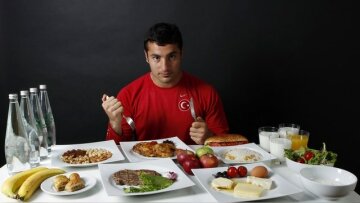Turkish javelin thrower and Olympic hopeful Fatih Avan poses in front of his daily meal intake in An