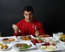 Turkish javelin thrower and Olympic hopeful Fatih Avan poses in front of his daily meal intake in An