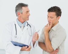 Male doctor in conversation with patient in the medical office