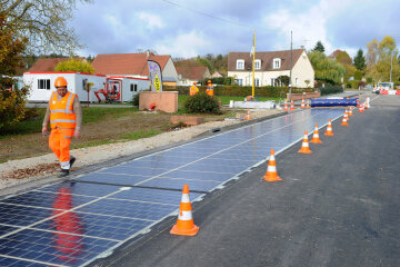 Solar panels, produced by Colas SA's Wattway unit, owned by Bouygues SA, are laid onto a road in this undated handout photo released to the media on Wednesday, Nov. 23, 2016. A subsidiary of Bouygues SA has designed rugged solar panels, capable of withstand the weight of an 18-wheeler truck, that theyÕre now building into road surfaces. Source: Wattway