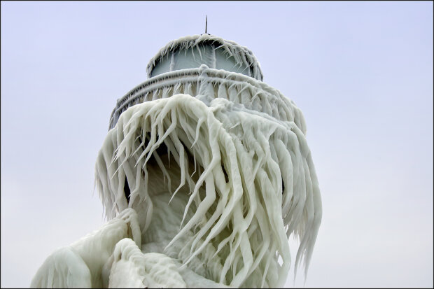 The St. Joseph, Michigan outer range light is covered in a thick layer of twisted ice following a winter storm that created 20 foot waves on Lake Michigan. The splashes from those waves created interesting ice patterns on the tower. As the wind changed direction during the storm, the ice began to twist.