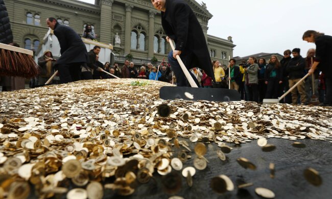 Committee members spread five cent coins over Federal Square during an event organised by the Commit