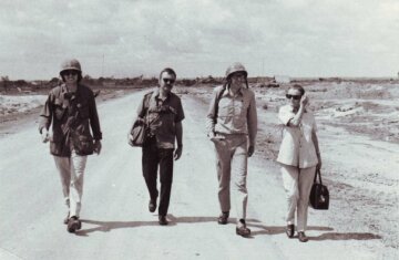 Clare and other hacks walking along a road – This is Clare with colleagues in Vietnam during the 1970s. Unknown photog. Clare Hollingworth collection.