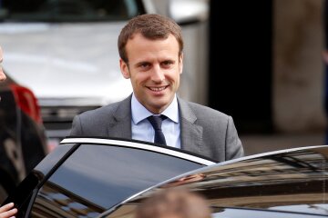 French Economy Minister Emmanuel Macron leaves the Elysee Palace after the weekly cabinet meeting in