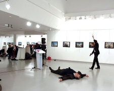 Russian Ambassador to Turkey Karlov lies on the ground after he was shot by unidentified man at an a