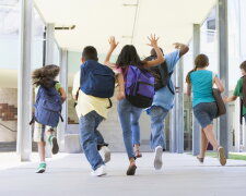 Elementary school pupils running outside