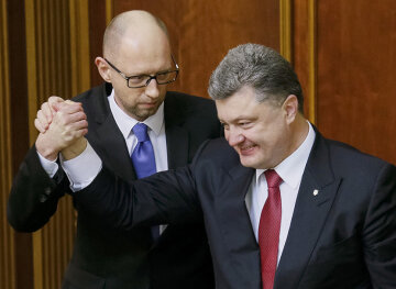 Ukraine's President Poroshenko congratulates newly appointed PM Yatseniuk during a session of the parliament in Kiev