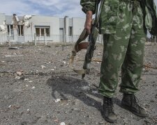 A pro-Russian rebel holds his rifle at the destroyed airport in Luhanks, eastern Ukraine