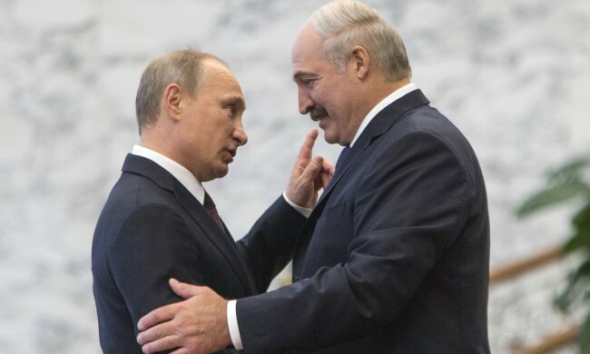 Belarus’ President Lukashenko greets his Russian counterpart Putin at a meeting during a CIS s