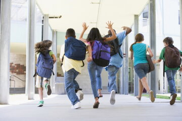 Elementary school pupils running outside