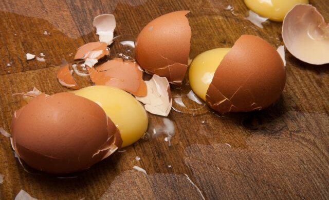 Broken eggs on the wooden floor