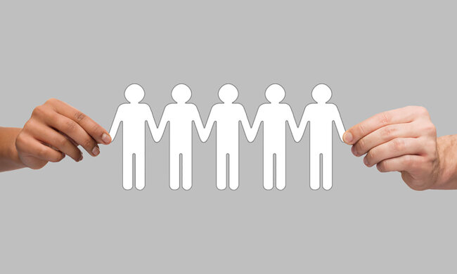 hands holding paper chain people