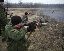 Volunteers of the separatist self-proclaimed Donetsk People’s Republican guard fire their weap