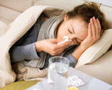 Sick Woman. Flu. Woman Caught Cold. Sneezing into Tissue